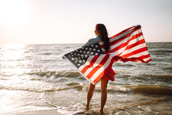 Woman on beach with American Flag